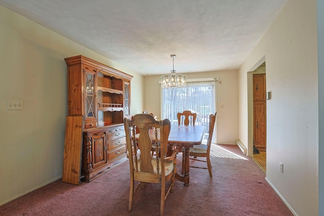 dining area featuring carpet floors, baseboards, and a notable chandelier