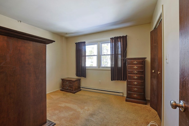 carpeted bedroom with a baseboard heating unit