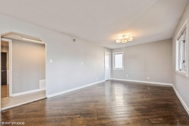 spare room with dark hardwood / wood-style flooring