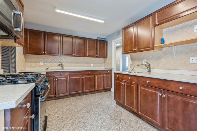 kitchen featuring backsplash, sink, and stainless steel appliances