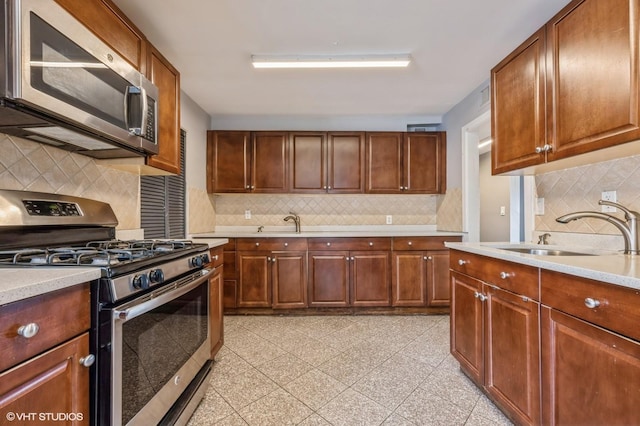 kitchen featuring backsplash, sink, and stainless steel appliances