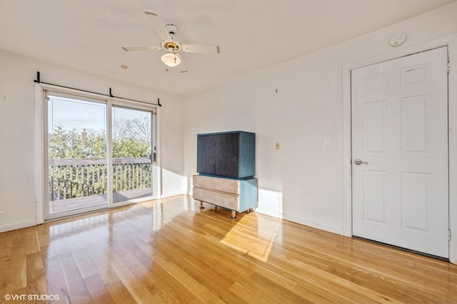 interior space with wood-type flooring and ceiling fan