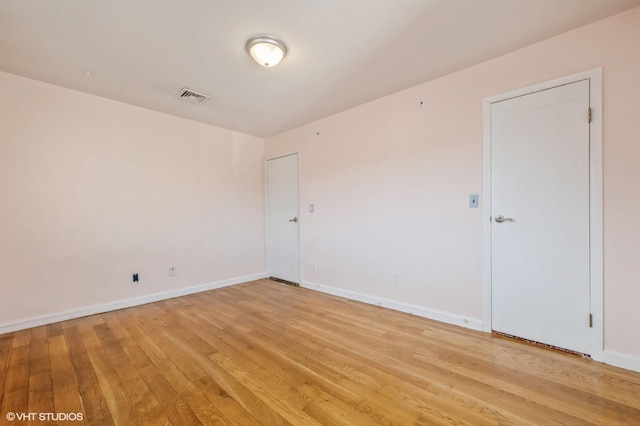 unfurnished room with light wood-type flooring