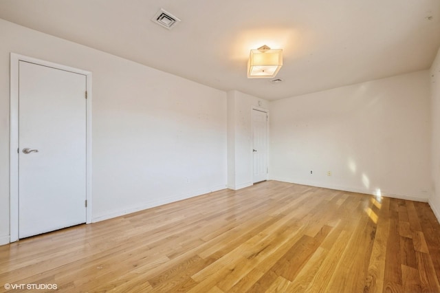 spare room featuring light hardwood / wood-style floors