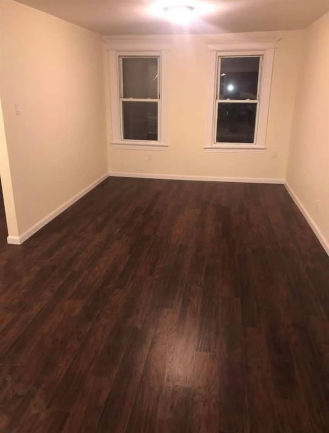 empty room with dark wood-type flooring