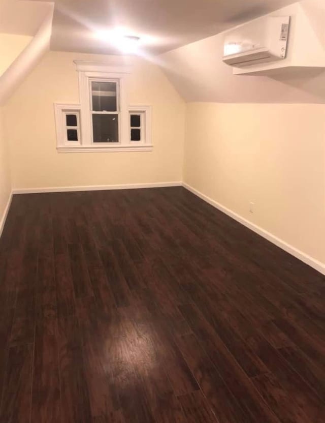 bonus room featuring dark hardwood / wood-style floors and lofted ceiling