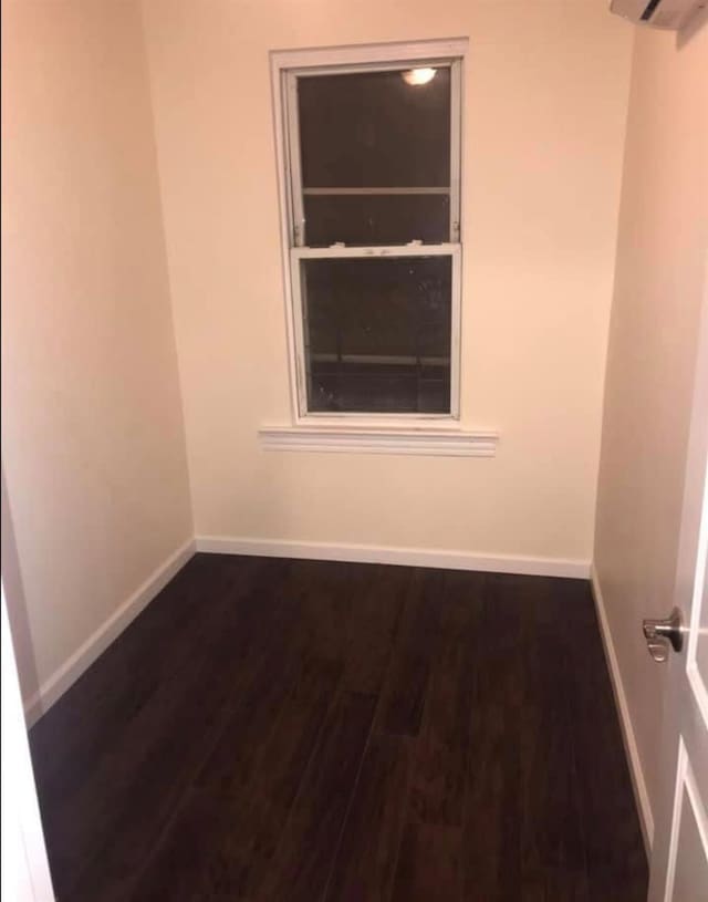 unfurnished room featuring dark hardwood / wood-style floors