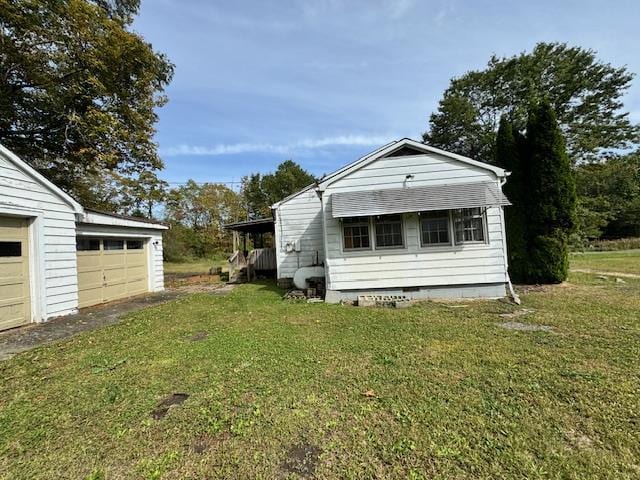 view of home's exterior with a garage and a lawn