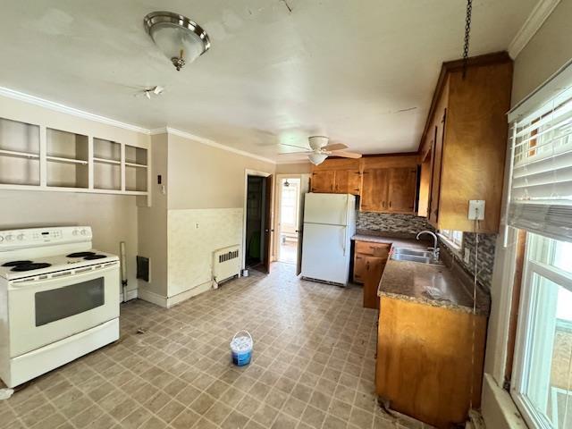 kitchen with white appliances, radiator, crown molding, sink, and ceiling fan