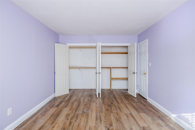 unfurnished bedroom with hardwood / wood-style flooring