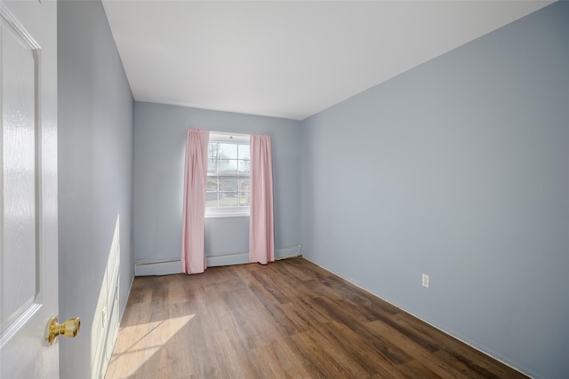 unfurnished room with light hardwood / wood-style floors and a baseboard radiator