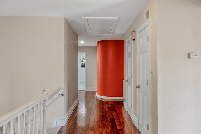 corridor with hardwood / wood-style flooring