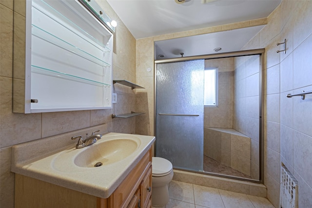 bathroom with tile walls, tile patterned flooring, toilet, and walk in shower