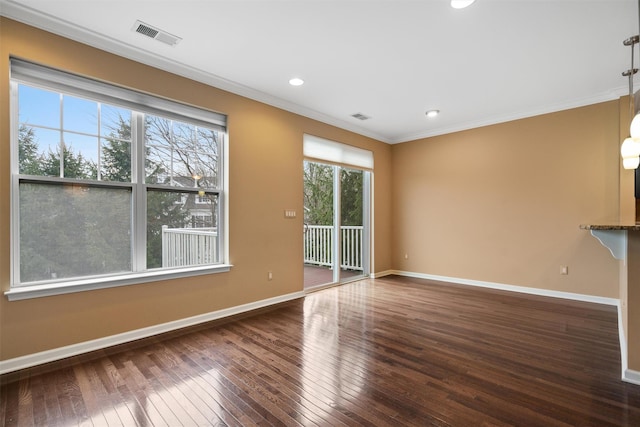 unfurnished living room featuring dark hardwood / wood-style flooring and ornamental molding