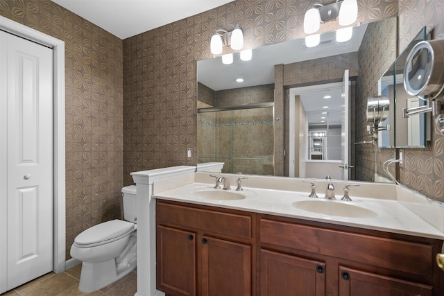 bathroom with tile patterned flooring, vanity, toilet, and a shower with door