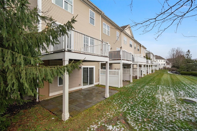 rear view of house featuring a yard and a patio