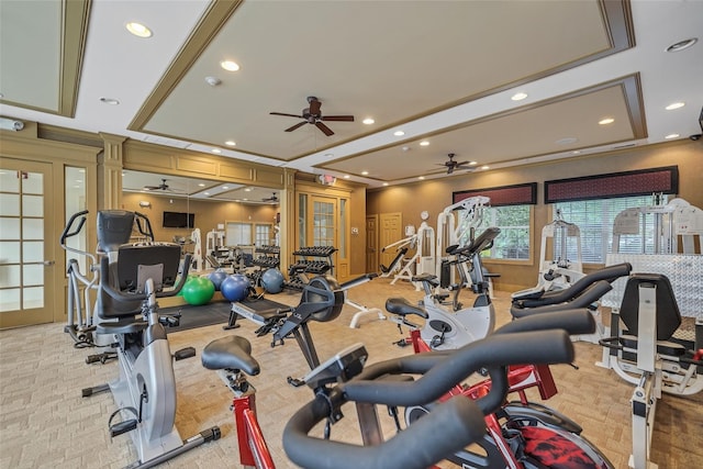 workout area featuring ceiling fan, a tray ceiling, light carpet, and recessed lighting