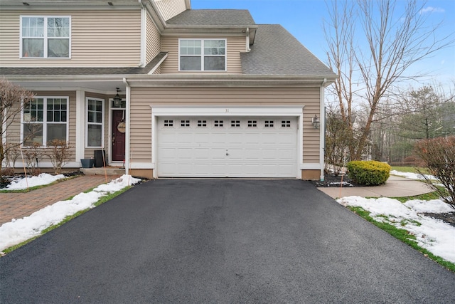 view of front of home featuring aphalt driveway and a shingled roof