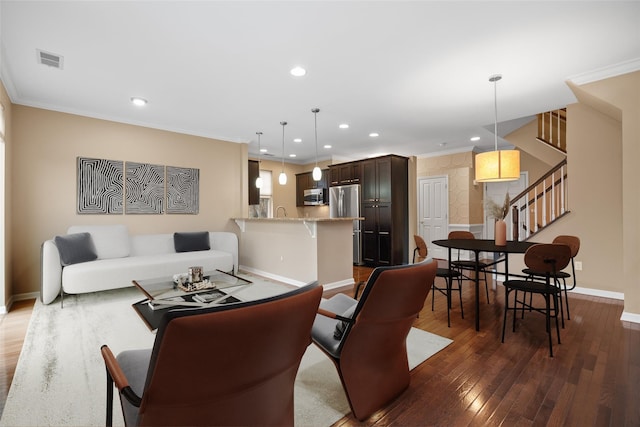 living area with recessed lighting, dark wood-style flooring, baseboards, ornamental molding, and stairway