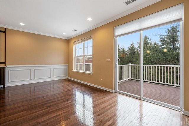 unfurnished room featuring visible vents, hardwood / wood-style flooring, a wainscoted wall, ornamental molding, and recessed lighting