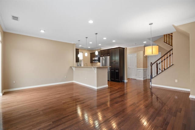 unfurnished living room featuring ornamental molding, dark wood finished floors, stairway, and baseboards