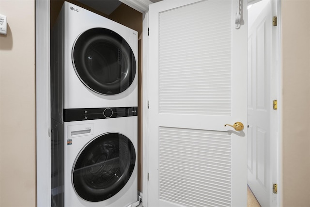 clothes washing area featuring laundry area and stacked washer and clothes dryer