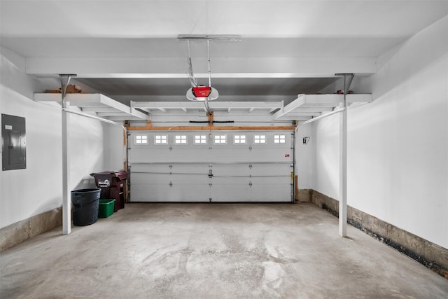 garage with electric panel and a garage door opener