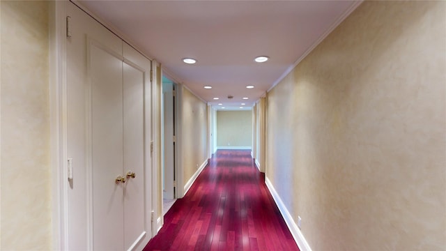 hall featuring dark hardwood / wood-style floors and crown molding