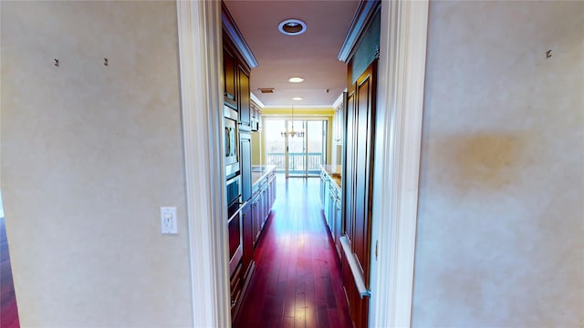 hall with dark hardwood / wood-style floors and ornamental molding