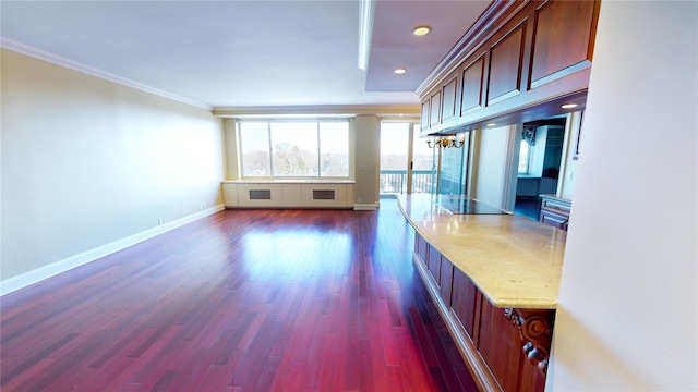 unfurnished living room featuring crown molding and dark wood-type flooring