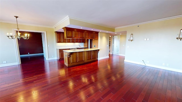 kitchen with dark wood-type flooring, decorative light fixtures, ornamental molding, and a notable chandelier