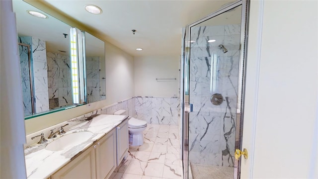 bathroom featuring vanity, toilet, an enclosed shower, and tile walls