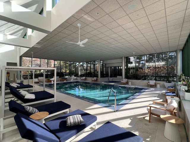 view of swimming pool featuring outdoor lounge area, ceiling fan, and a patio