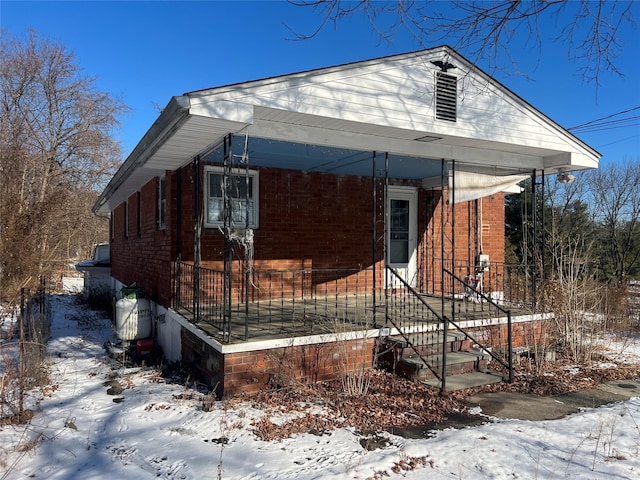 view of snow covered exterior with a porch