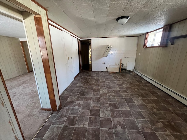 basement with baseboard heating and wood walls