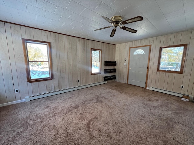 interior space with carpet flooring, baseboard heating, and ceiling fan