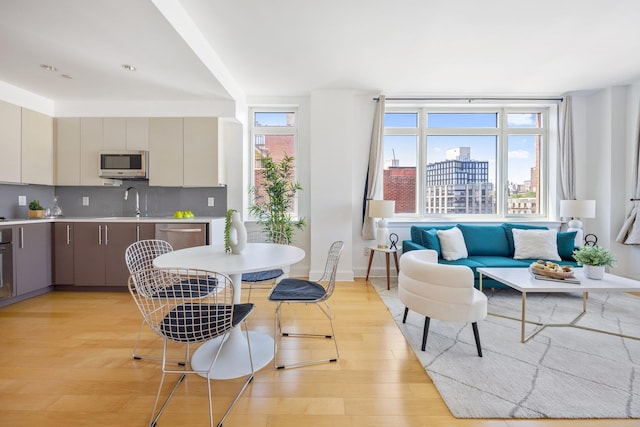 dining area featuring light hardwood / wood-style flooring and sink