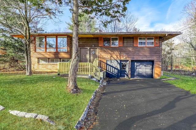 bi-level home with a garage and a front lawn