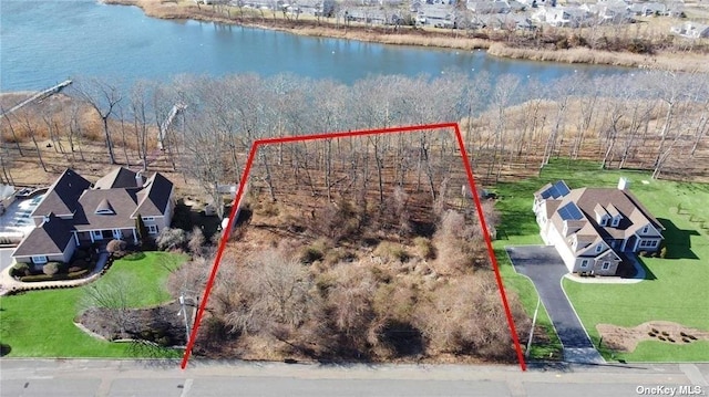 birds eye view of property featuring a water view