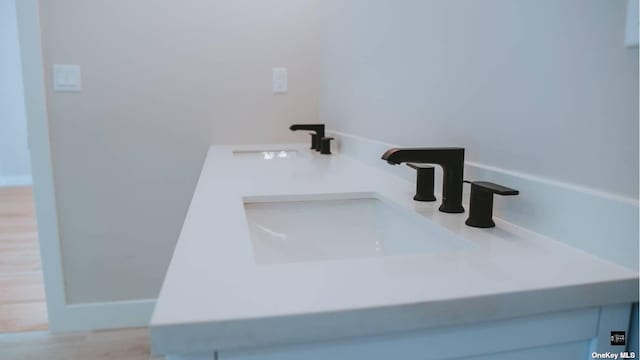 room details featuring hardwood / wood-style flooring and sink