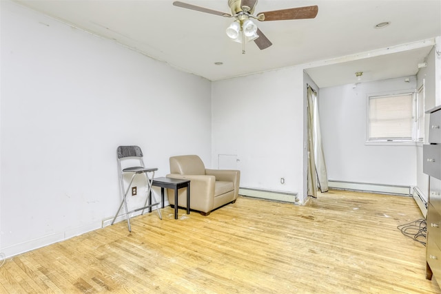 sitting room featuring ceiling fan, light hardwood / wood-style floors, and a baseboard radiator