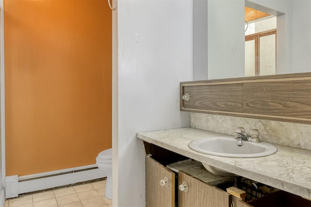 bathroom with tile patterned floors, vanity, a baseboard radiator, and toilet