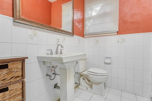 bathroom featuring tile patterned flooring, tile walls, and toilet