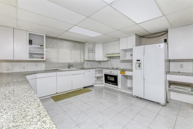 kitchen with a drop ceiling, white appliances, sink, decorative backsplash, and white cabinetry