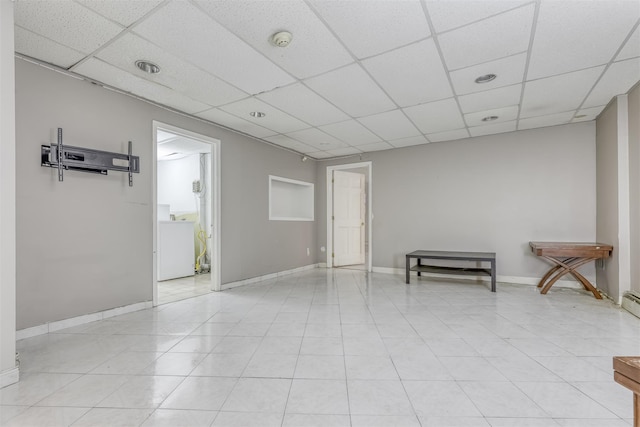 unfurnished room featuring a drop ceiling and light tile patterned floors