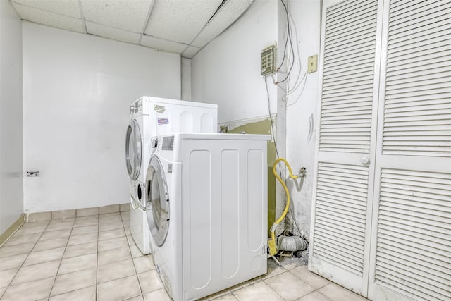 clothes washing area with light tile patterned floors