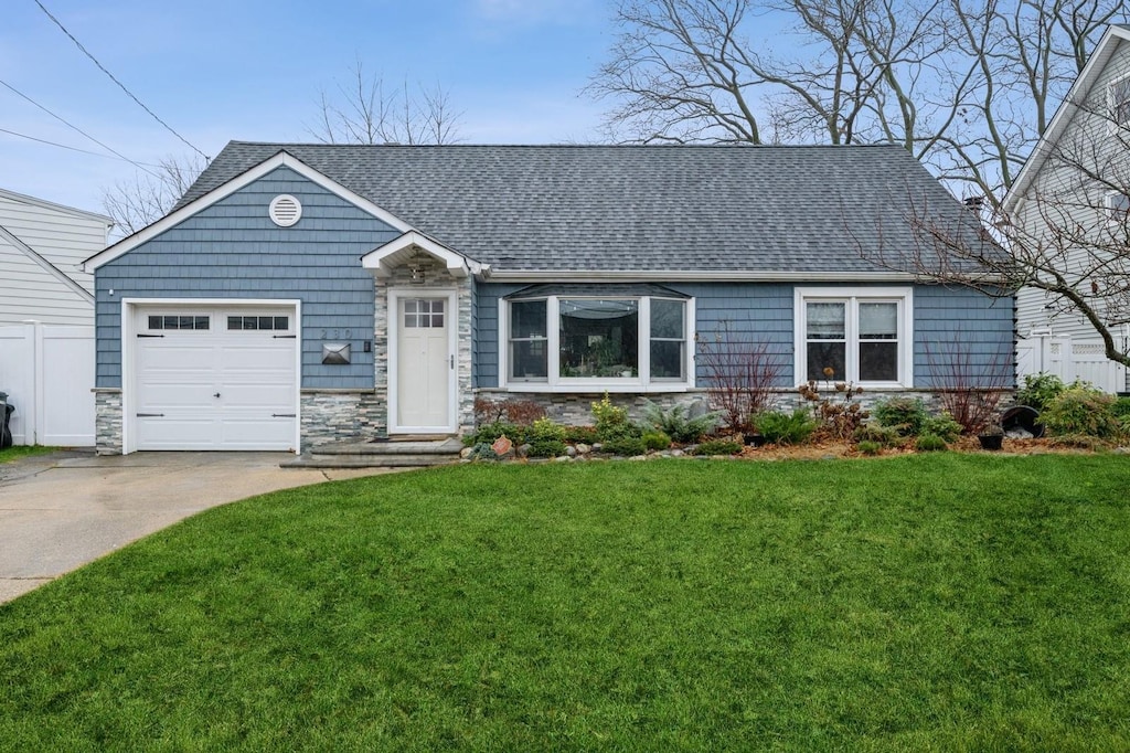 view of front facade with a front yard and a garage