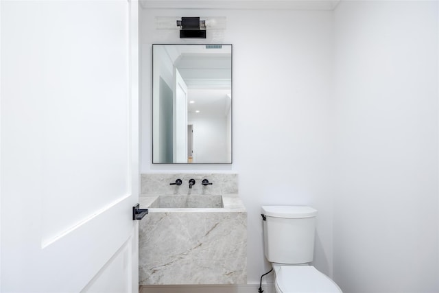 bathroom featuring toilet and sink