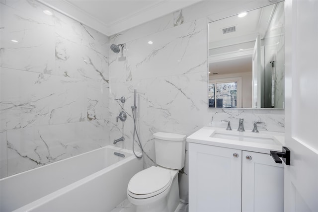 full bathroom featuring vanity, crown molding, tiled shower / bath, toilet, and tile walls