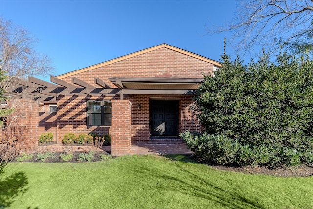 view of front of property featuring a front yard and brick siding